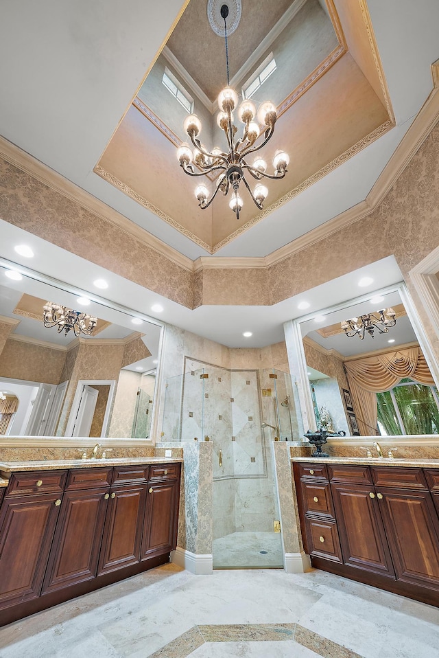 bathroom featuring ornamental molding, a chandelier, vanity, a tray ceiling, and a shower with door