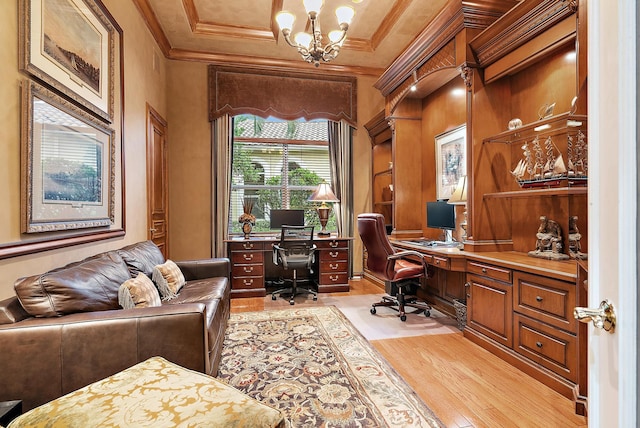 office area with light hardwood / wood-style flooring, crown molding, a chandelier, and built in desk