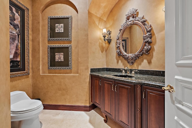 bathroom featuring tile patterned flooring, vanity, and toilet