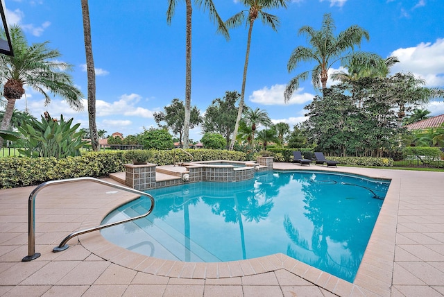 view of pool with an in ground hot tub