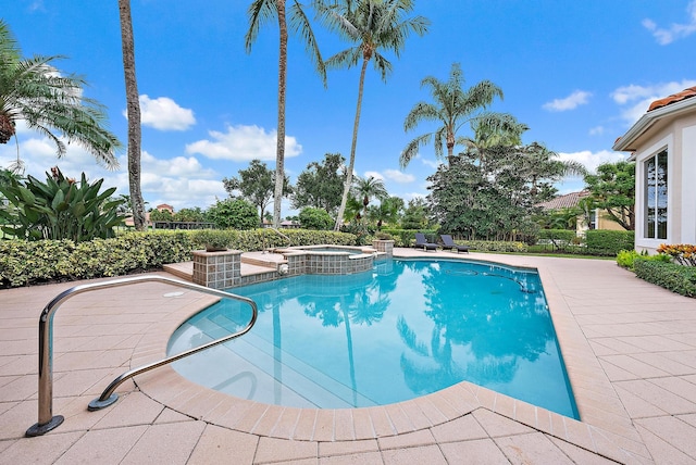 view of swimming pool with a patio area and an in ground hot tub