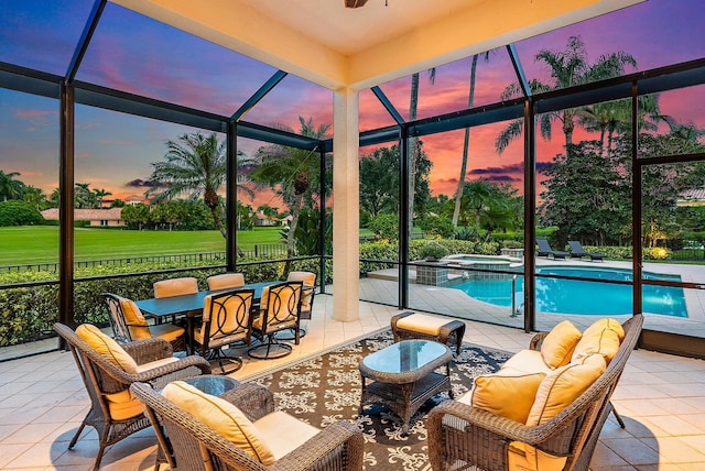 exterior space featuring glass enclosure, an in ground hot tub, and a patio