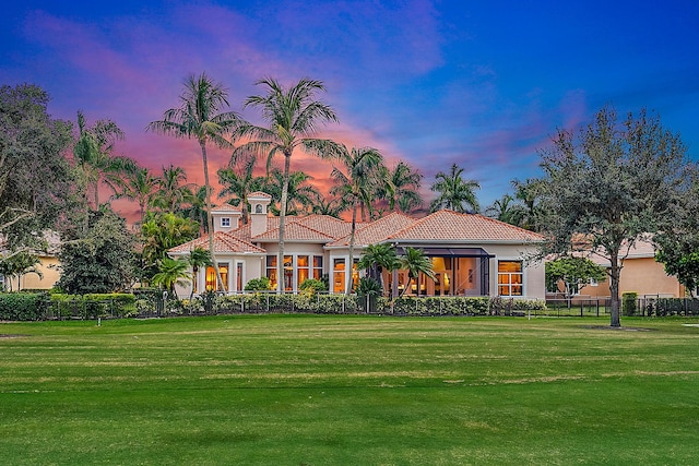 mediterranean / spanish-style home featuring a yard