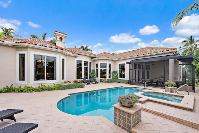 view of swimming pool featuring an in ground hot tub, a patio, and ceiling fan