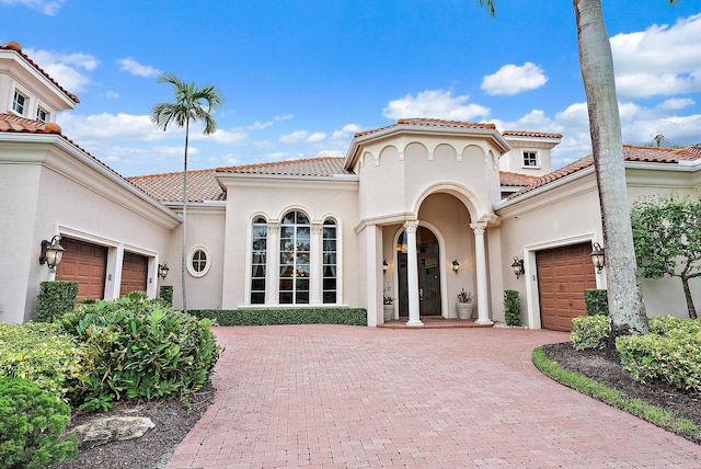 mediterranean / spanish house featuring a garage