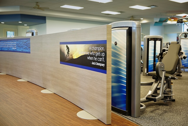 exercise room with ceiling fan