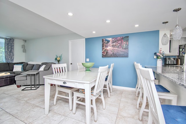 dining space featuring light tile patterned flooring