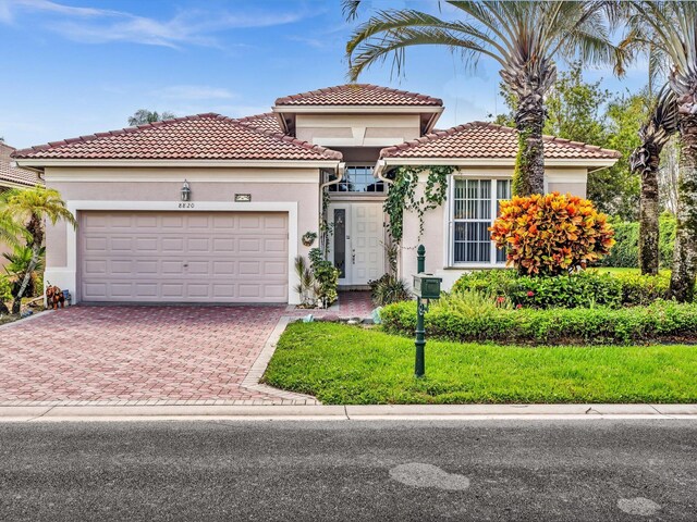 mediterranean / spanish house featuring a garage