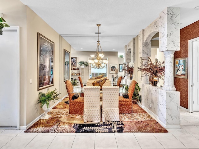 dining room featuring light tile patterned flooring, a chandelier, and a textured ceiling