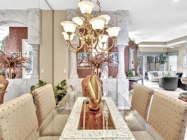 dining area featuring ceiling fan with notable chandelier