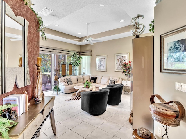 living room featuring visible vents, light tile patterned floors, recessed lighting, a textured ceiling, and a ceiling fan