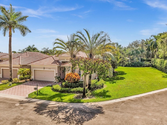 view of front of home with a front lawn and a garage