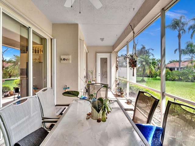 sunroom / solarium with a healthy amount of sunlight and ceiling fan