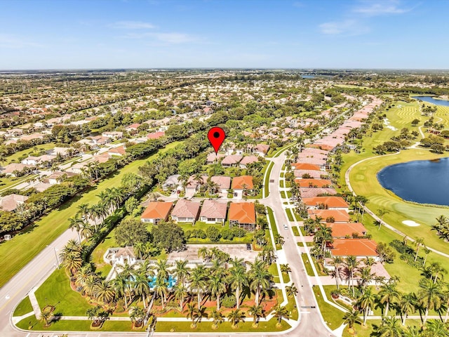 aerial view with view of golf course, a water view, and a residential view