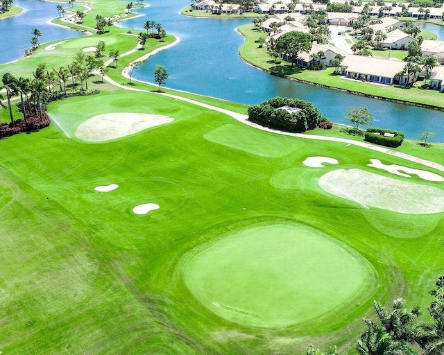 drone / aerial view featuring a residential view, a water view, and view of golf course