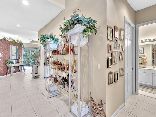 hallway with light tile patterned floors, recessed lighting, and baseboards