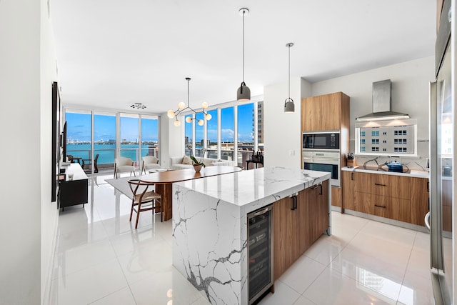 kitchen with wine cooler, a water view, tasteful backsplash, stainless steel oven, and wall chimney range hood