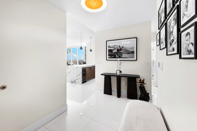 hallway with beverage cooler and light tile patterned floors