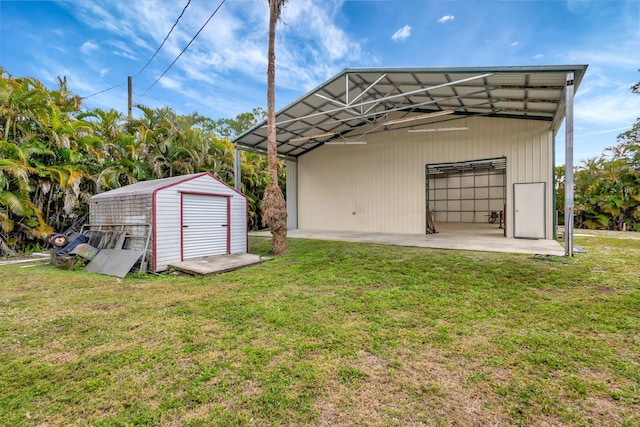 view of outbuilding with a yard and a garage