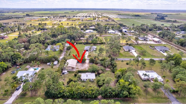 birds eye view of property with a rural view