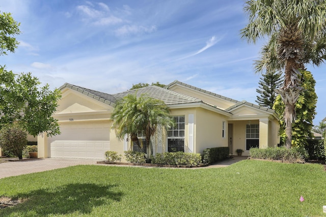 ranch-style house featuring an attached garage, a front lawn, decorative driveway, and stucco siding