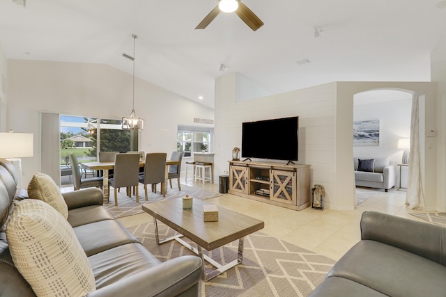 living room with arched walkways, light tile patterned flooring, plenty of natural light, and ceiling fan