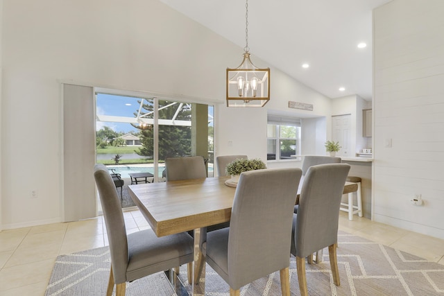 dining space with light tile patterned floors, recessed lighting, high vaulted ceiling, and an inviting chandelier