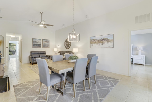 dining space featuring light tile patterned floors, high vaulted ceiling, ceiling fan, visible vents, and baseboards