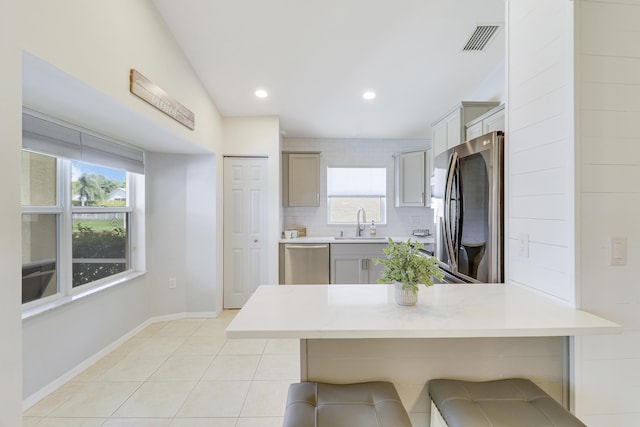 kitchen featuring stainless steel appliances, light countertops, visible vents, and a sink