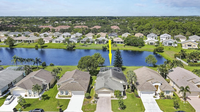 drone / aerial view featuring a residential view and a water view