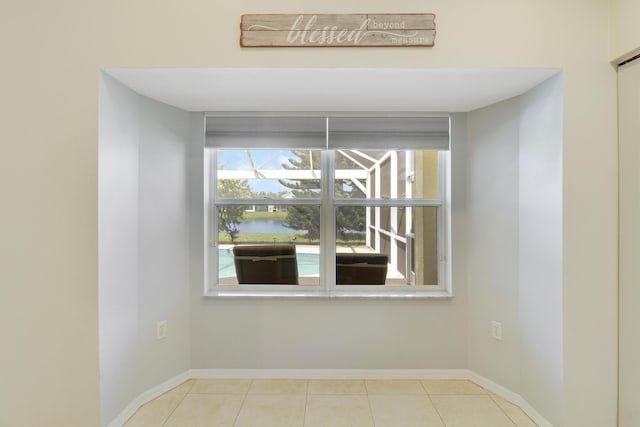 spare room featuring baseboards and tile patterned floors