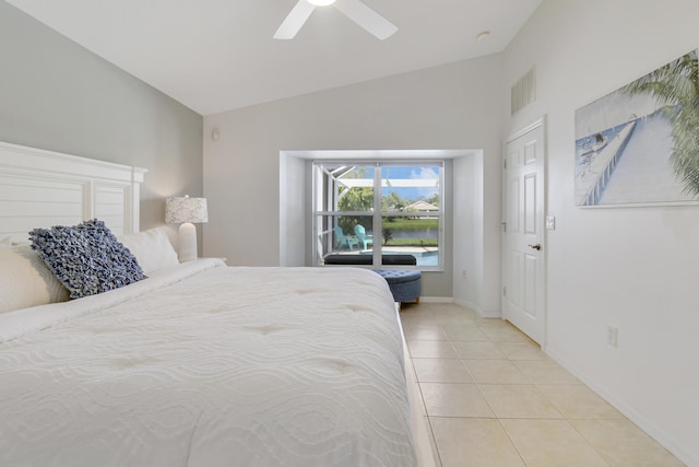 bedroom featuring light tile patterned floors, visible vents, baseboards, lofted ceiling, and ceiling fan