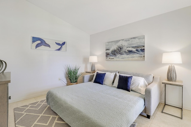 bedroom featuring baseboards, vaulted ceiling, and tile patterned floors