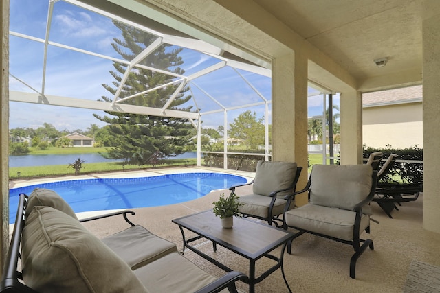 pool with a lanai, a water view, a patio, and outdoor lounge area