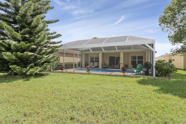 rear view of house featuring glass enclosure, an outdoor pool, a patio, and a yard