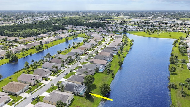 birds eye view of property with a residential view and a water view