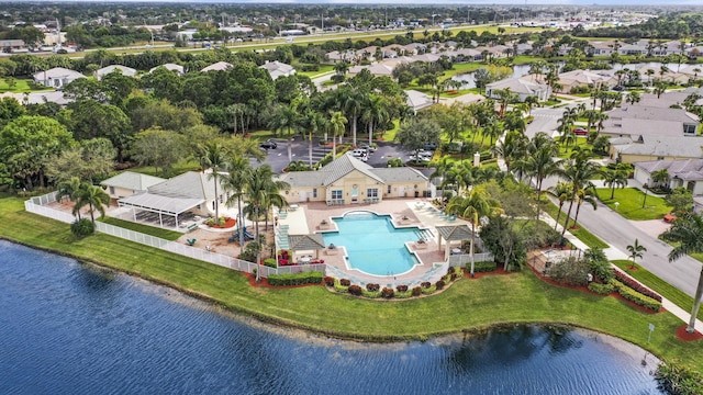 drone / aerial view with a residential view and a water view