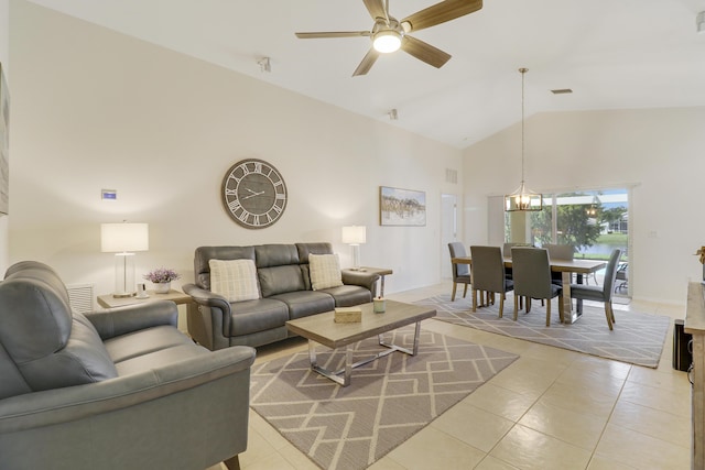 living room featuring light tile patterned floors, high vaulted ceiling, ceiling fan with notable chandelier, visible vents, and baseboards