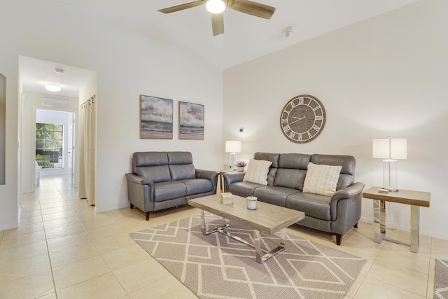 living area featuring light tile patterned floors, visible vents, baseboards, a ceiling fan, and high vaulted ceiling