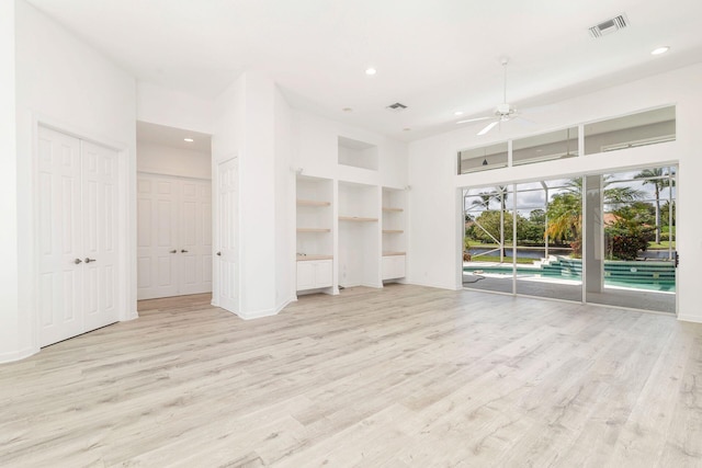 unfurnished living room featuring light hardwood / wood-style flooring, built in features, and ceiling fan