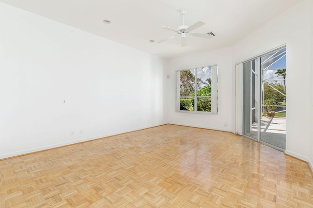 empty room with ceiling fan and light parquet flooring