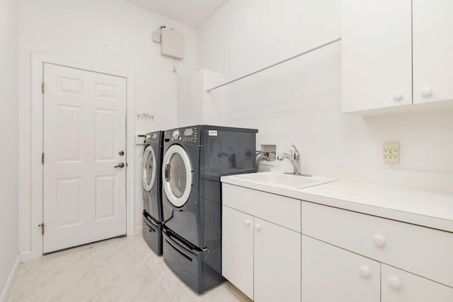 laundry room featuring cabinets, sink, separate washer and dryer, and light tile patterned floors