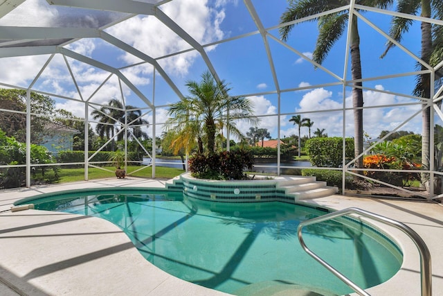 view of swimming pool featuring a patio and a lanai