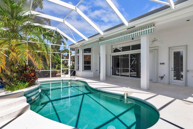 view of pool with a patio area, a lanai, and ceiling fan