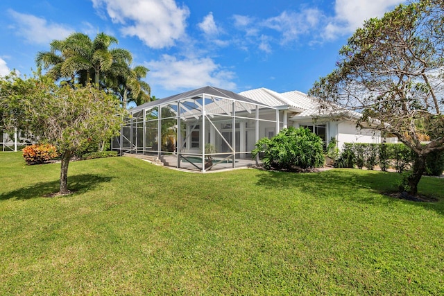 view of yard with a swimming pool and glass enclosure