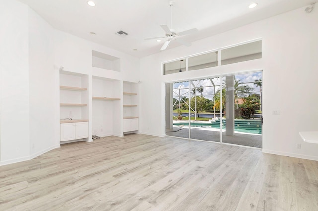 unfurnished living room with light hardwood / wood-style floors, built in features, and ceiling fan