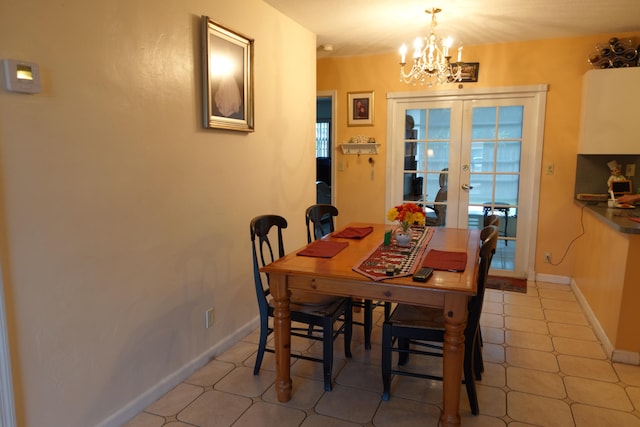 dining area featuring light tile patterned floors, french doors, and a chandelier