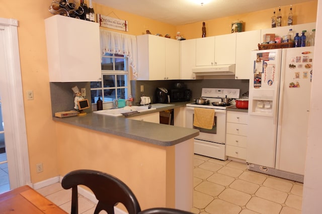 kitchen featuring white cabinetry, backsplash, light tile patterned floors, and white appliances