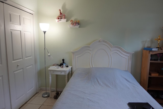 tiled bedroom featuring a closet