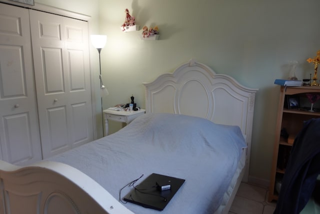 bedroom featuring tile patterned floors and a closet